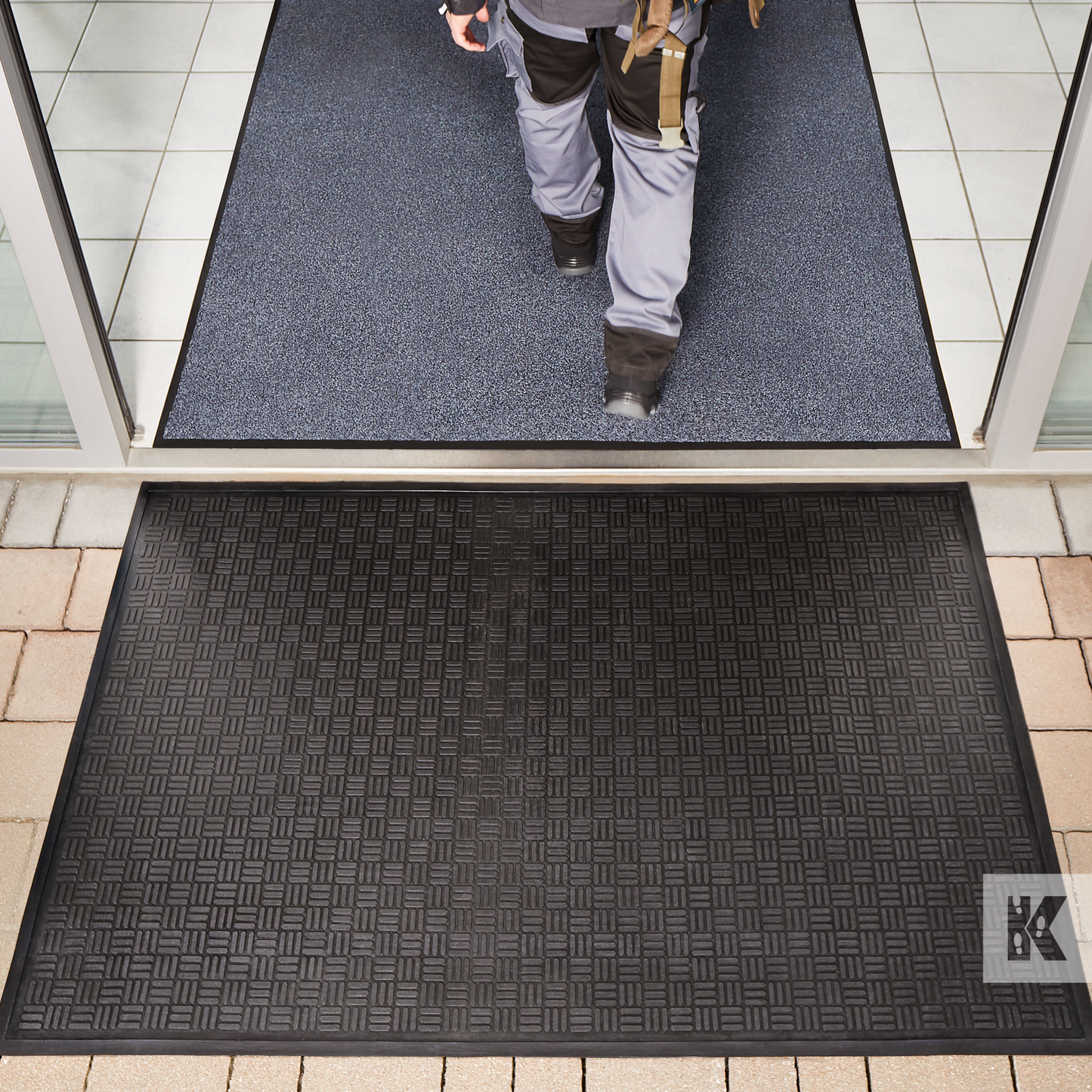 Kleen-Scrape - Man walks into a public entrance, crossing over a Kleen-Scrape mat in position 1 then an Iron-Horse mat in position 2