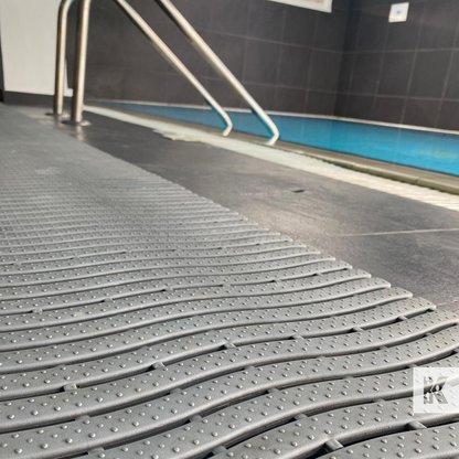 Kleen-Wave drainage matting next to an indoor pool in a spa